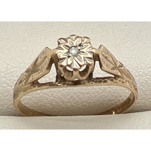 1123 - A 9ct gold and diamond solitaire ring with engraved detail to shoulders. Fully hallmarked inside ban... 