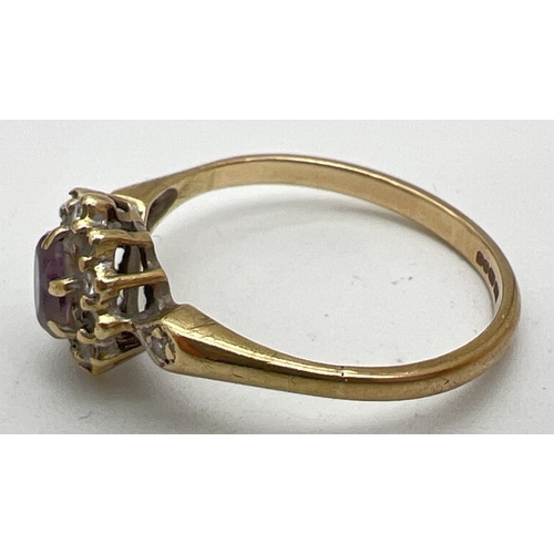 1124 - A 9ct gold, amethyst and diamond ring with central oval cut amethyst surrounded by small round cut d... 