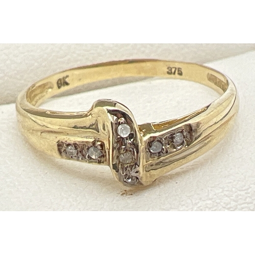 1125 - A 9ct gold and diamond set ring with a crossover design mount set with 7 small round cut diamonds. S... 