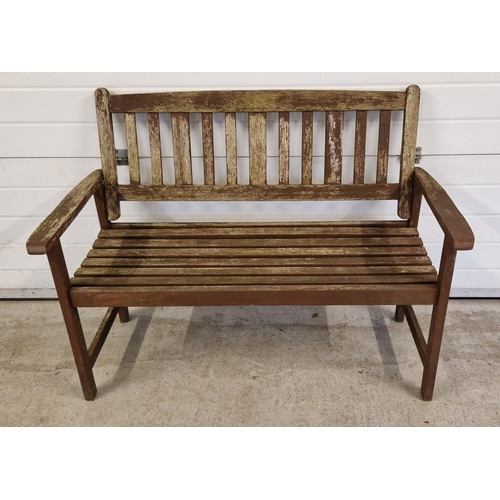 1427 - A modern wooden slatted garden bench, painted brown. Approx. 88cm tall x 120.5cm long.