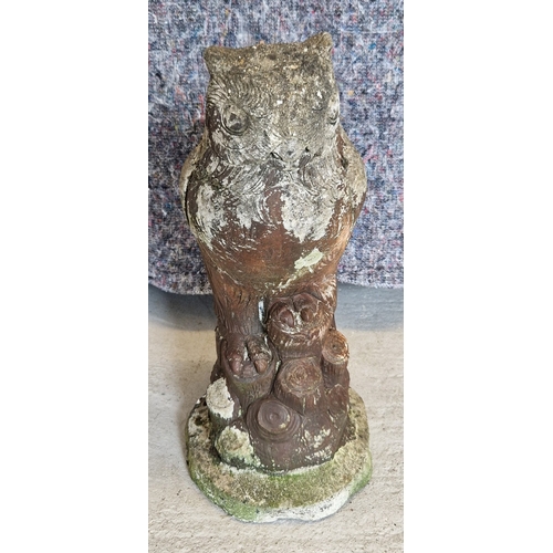 1431 - A large concrete garden ornament of an owl on a branch. Approx. 43cm tall.