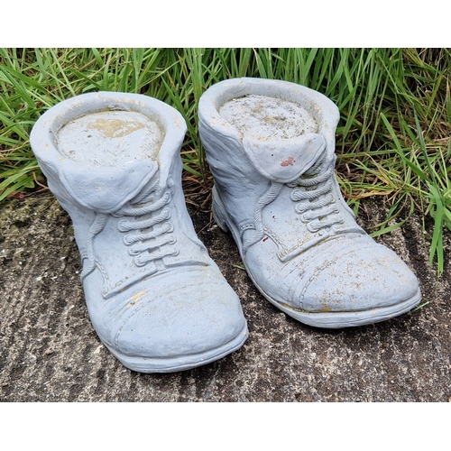 1439 - A pair of concrete garden ornaments modelled as boots. Each approx. 20cm tall x 38cm long.