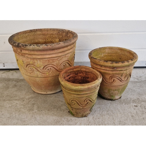 1441 - A set of 3 graduating terracotta garden planters with banded swirl design. Largest approx. 32cm tall... 