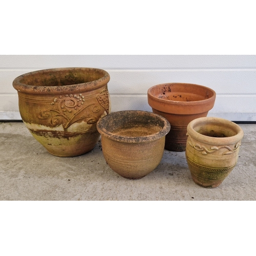 1451 - 4 assorted terracotta garden pots of varying sizes and designs. Largest approx. 30cm tall x 35cm dia... 