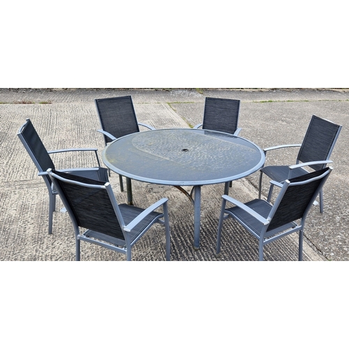 1452 - A large modern metal framed circular garden table and 6 chairs. Table has glass top and central hole... 