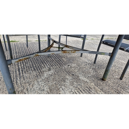 1452 - A large modern metal framed circular garden table and 6 chairs. Table has glass top and central hole... 