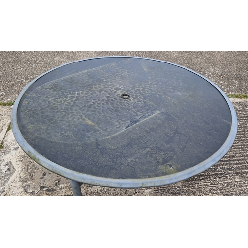 1452 - A large modern metal framed circular garden table and 6 chairs. Table has glass top and central hole... 