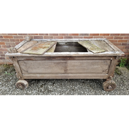 1462 - A large vintage wooden trough on wheels, possibly a day bed with head support missing. Approx. 80cm ... 