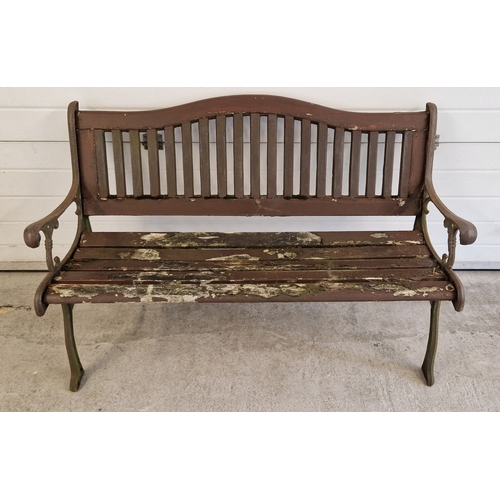 1467 - A wooden slatted garden bench with cast iron bench ends. Approx. 128cm long.