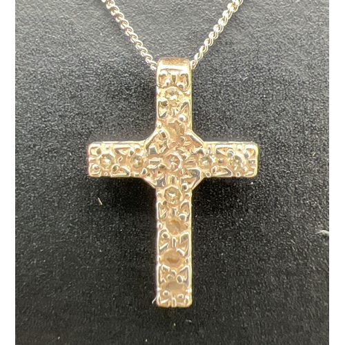 1133 - A small 9ct white gold diamond set cross pendant necklace. Cross pendant (1.25cm long) set with 11 s... 