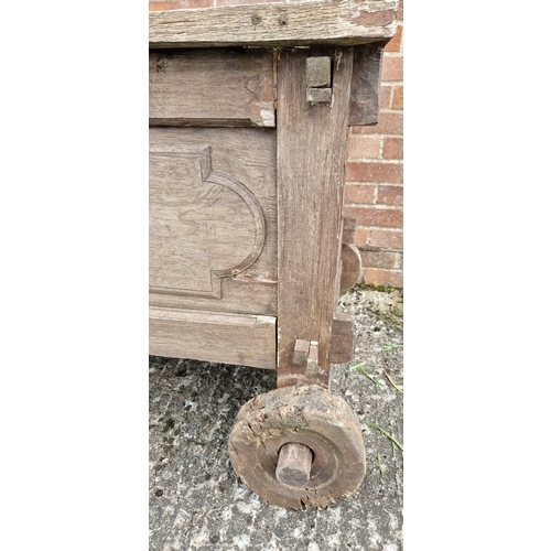 1462 - A large vintage wooden trough on wheels, possibly a day bed with head support missing. Approx. 80cm ... 