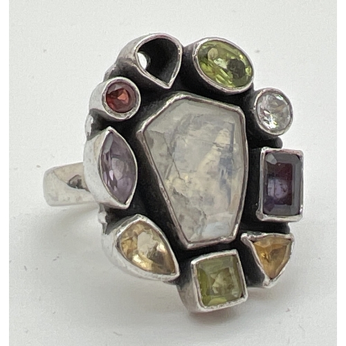 1030 - A modern design multi stone set silver ring (one stone missing). Stones cut in various shapes and si... 