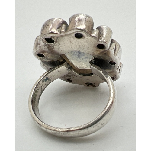 1030 - A modern design multi stone set silver ring (one stone missing). Stones cut in various shapes and si... 