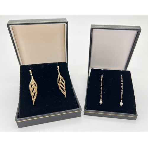 1064 - 2 pairs of vintage gold, drop style earrings. A pair leaf design drops (unmarked - test as 9ct) toge... 