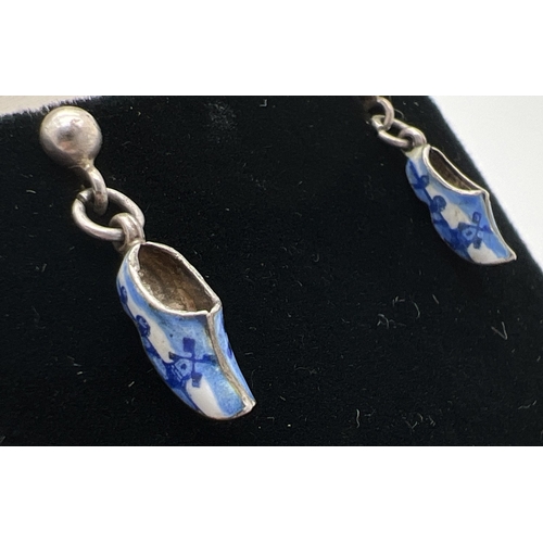 1096 - A pair of vintage Dutch white metal enamelled clog earrings with blue & white windmill designs. Scre... 