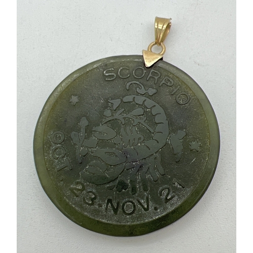 1098 - A Chinese Jade circular shaped pendant engraved with Scorpio star sign detail, on a 14ct gold bale. ... 