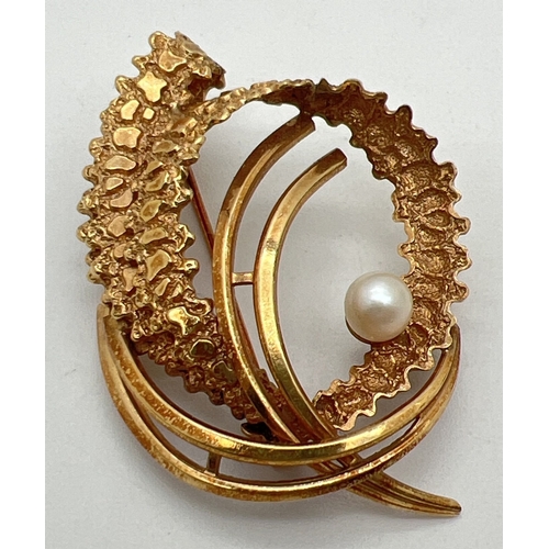 1126 - A vintage 1960's rolled gold brooch set with a single pearl. Retro twist and swirl design with both ... 