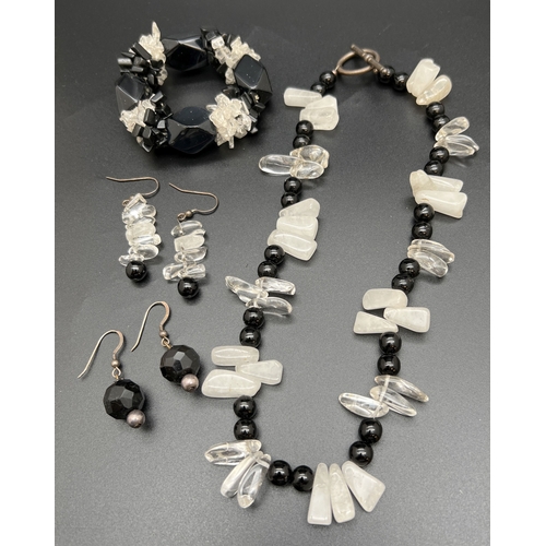 1160 - A modern design onyx, clear and opaque rock crystal necklace with silver T Bar clasp. Together with ... 