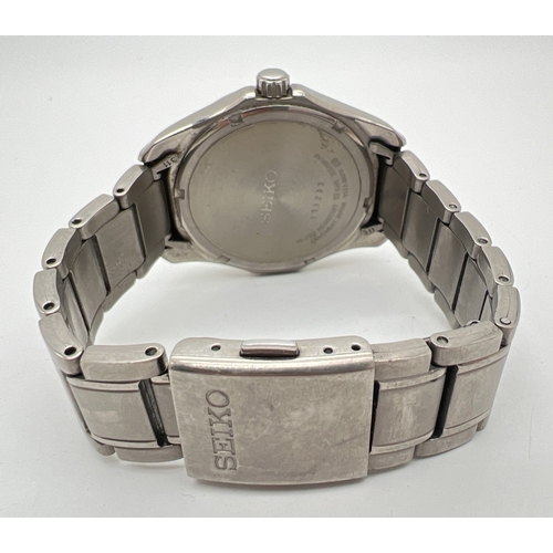 1172 - A men's Seiko Solar Titanium wristwatch with silver tone titanium case and bracelet strap. White fac... 