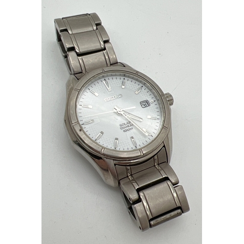 1172 - A men's Seiko Solar Titanium wristwatch with silver tone titanium case and bracelet strap. White fac... 