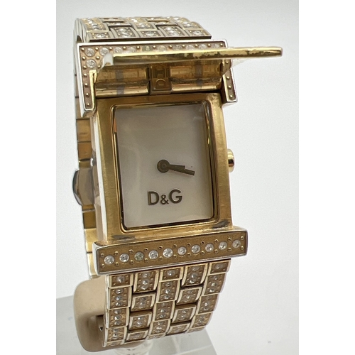 1185 - A Dolce & Gabbana DW0377 Prime Time crystal set bracelet wristwatch. Gold tone case and strap set wi... 