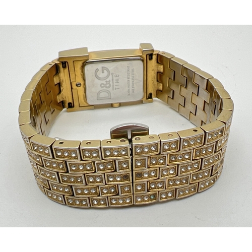 1185 - A Dolce & Gabbana DW0377 Prime Time crystal set bracelet wristwatch. Gold tone case and strap set wi... 