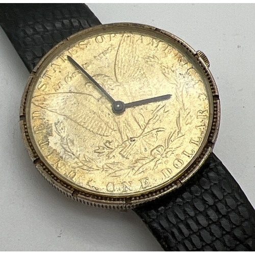 1188 - A men's silver cased wristwatch with American one dollar coin face. Brushed effect silver to reverse... 