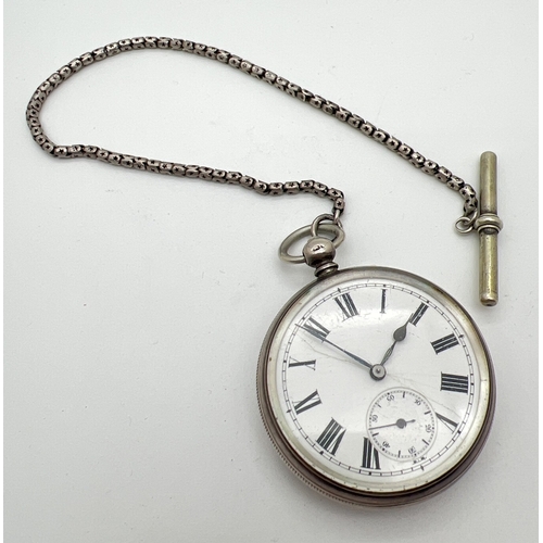 1194 - A Victorian silver cased pocket watch with white metal chain and albert. Engine turned decoration to... 