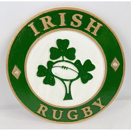 1255 - A circular painted cast iron Irish Rugby wall plaque, with fixing holes. Approx. 24cm diameter.