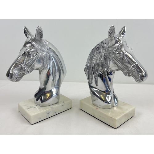 1260 - A pair of modern cast metal horse head figures mounted on square shaped marble bases. Each approx. 2... 