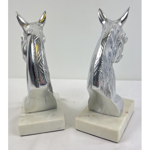 1260 - A pair of modern cast metal horse head figures mounted on square shaped marble bases. Each approx. 2... 