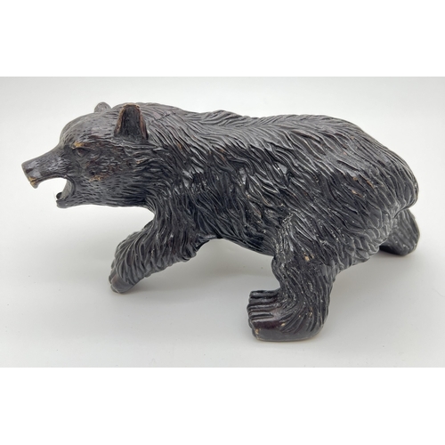 1265 - A hollow bronze figure modelled as a bear. Approx. 10.5cm tall x 22.5cm long.