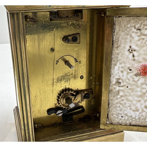 1273 - An antique French brass carriage clock with white enamel face and enameled back and side panels, dec... 