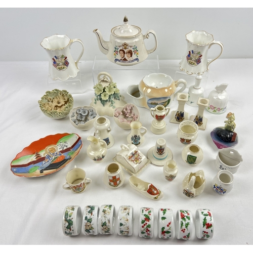 1291 - A box of assorted vintage ceramics to include crested ware china, Isle of White studio pottery ornam... 