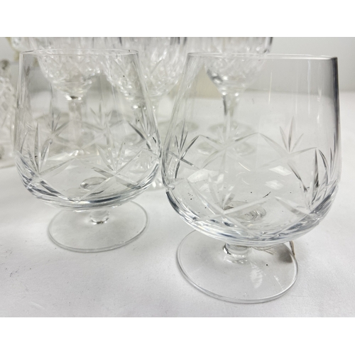 1307 - A collection of assorted cut clear glass and crystal to include a set of 8 wine glasses, brandy snif... 