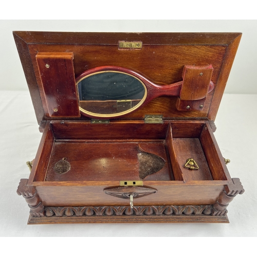 1359 - An antique dark wood bespoke made lockable vanity box with carved and inlaid detail. Raised on bun f... 