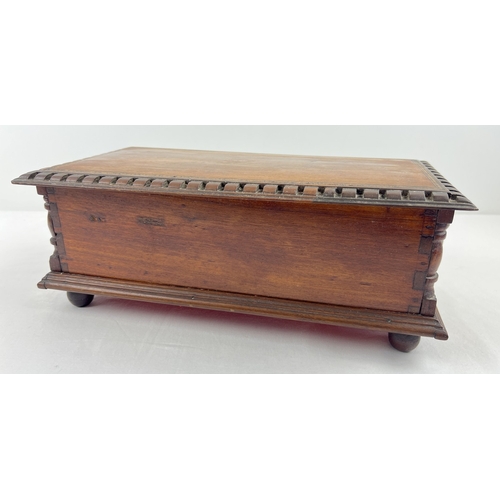 1359 - An antique dark wood bespoke made lockable vanity box with carved and inlaid detail. Raised on bun f... 