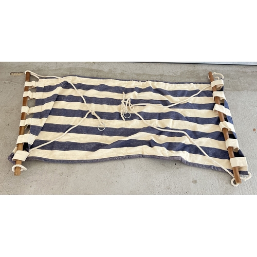 1415 - A large blue & white striped canvas garden hammock with wooden spreader bars. With thick rope and me... 