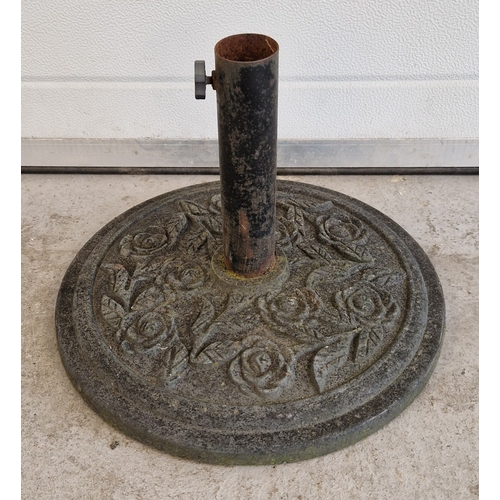 1454 - A circular shaped cast metal garden parasol stand with embossed floral design. Approx. 30cm tall x 4... 