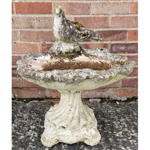 1458 - A 2 sectional concrete garden bird bath modelled as a scallop shell with a bird sat on top. Approx. ... 