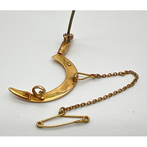 1123 - An Edwardian unmarked gold brooch in the shape of a hand scythe, with safety chain. No gold marks bu... 