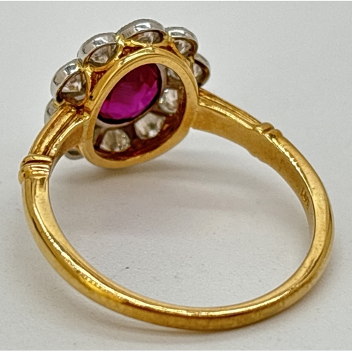 1 - A ruby and diamond cluster ring comprised of a central oval cut ruby with a surround of ten platinum... 