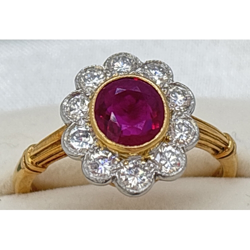 1 - A ruby and diamond cluster ring comprised of a central oval cut ruby with a surround of ten platinum... 