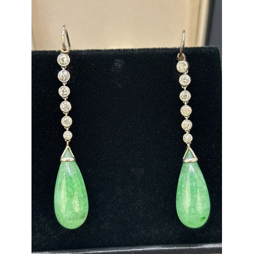 3 - A pair of white metal Art Deco diamond and jade drop earrings with hook posts. Each earring comprise... 