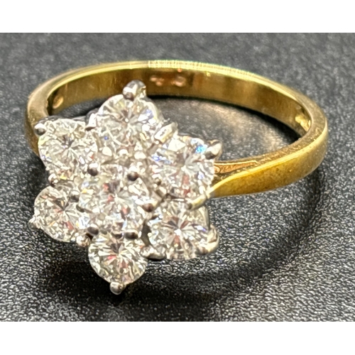 5 - A 18ct gold seven stone brilliant cut diamond flower design cluster ring. Stones in 18ct white gold ... 