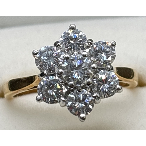 5 - A 18ct gold seven stone brilliant cut diamond flower design cluster ring. Stones in 18ct white gold ... 