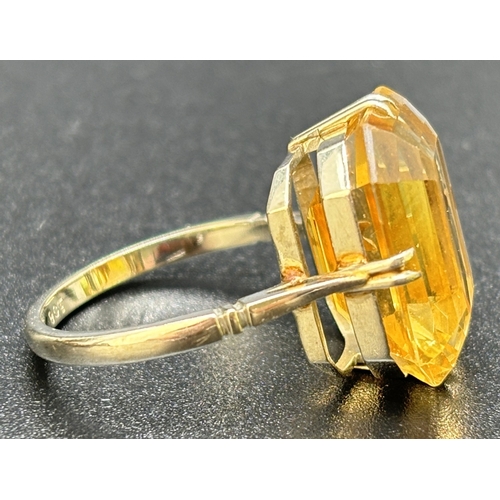 9 - A vintage 9ct white gold and citrine cocktail ring, double claw prong set with a large emerald cut a... 