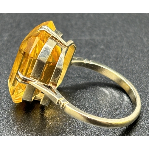 9 - A vintage 9ct white gold and citrine cocktail ring, double claw prong set with a large emerald cut a... 