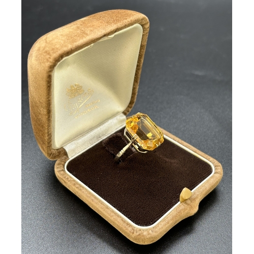 9 - A vintage 9ct white gold and citrine cocktail ring, double claw prong set with a large emerald cut a... 