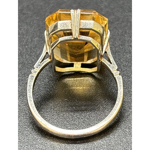 9 - A vintage 9ct white gold and citrine cocktail ring, double claw prong set with a large emerald cut a... 